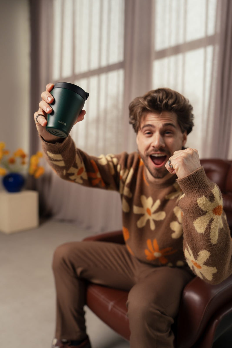 Man cheering with his FLASKE cup
