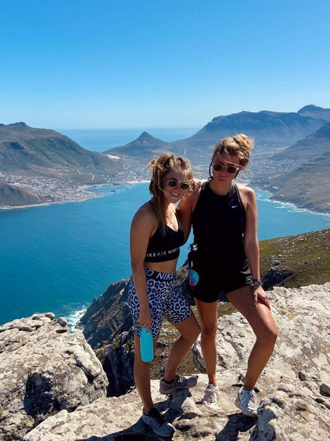 Two friends on a mountain with FLASKE bottles