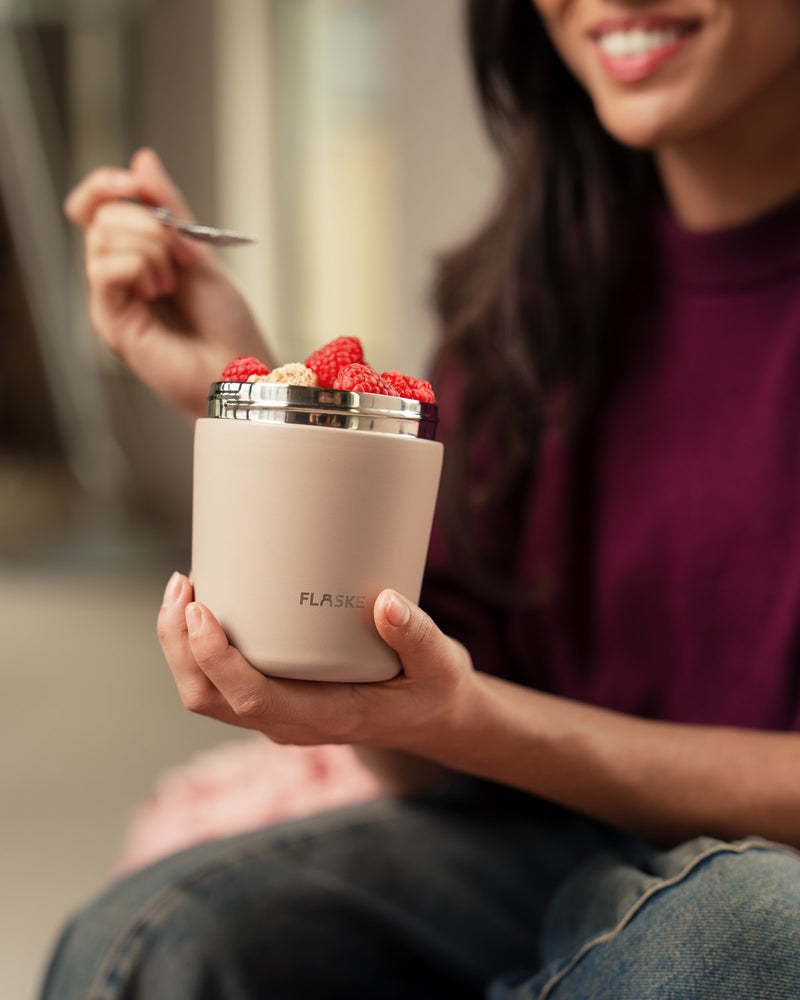 Woman eating from her FLASKE Muesli Bowl