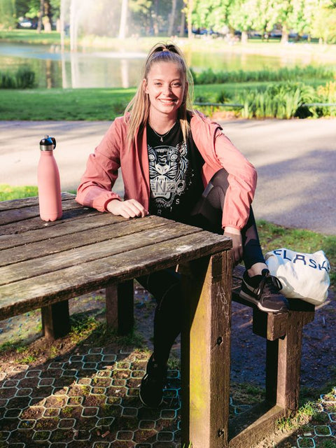 Woman at a picnic table with her FLASKE